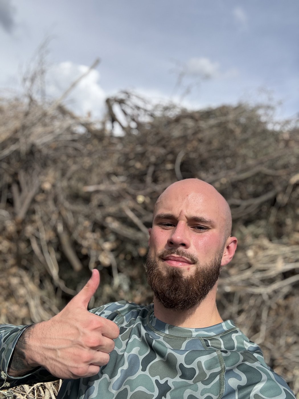 Blake Lannan, owner of VetsOnCall Junk Removal, at a brush and debris pile after a Tucson yard haul